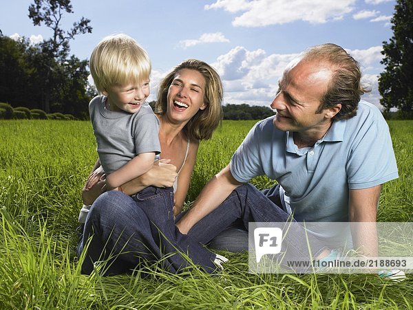 Family enjoying a good time in a field.