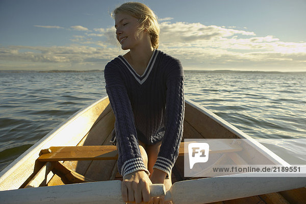 Young woman in rowing boat.