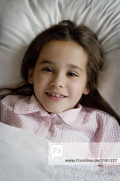 Portrait of a young girl in bed.