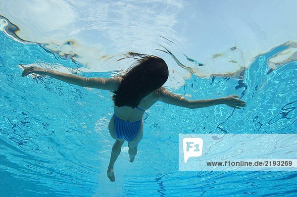 Schwimmende Frau im Schwimmbad  Unterwassersicht