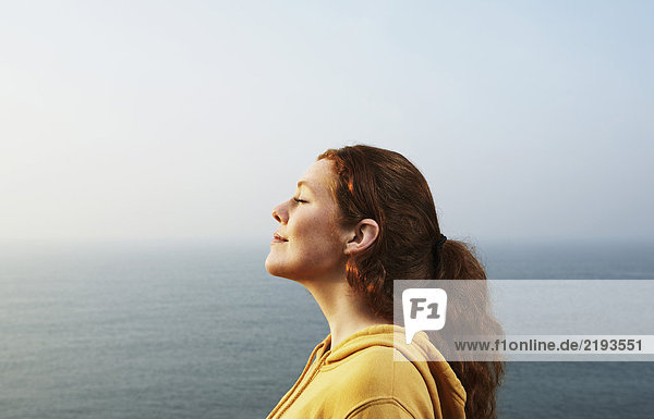 Profile of a young Woman by the sea.