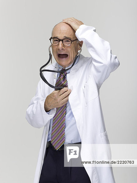 Portrait of a senior male doctor  holding stethoscope
