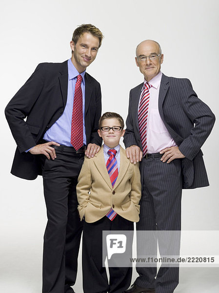 Grandson (8-9) grandfather and son wearing business cloth  portrait