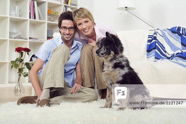 Couple in living room  with dog  portrait