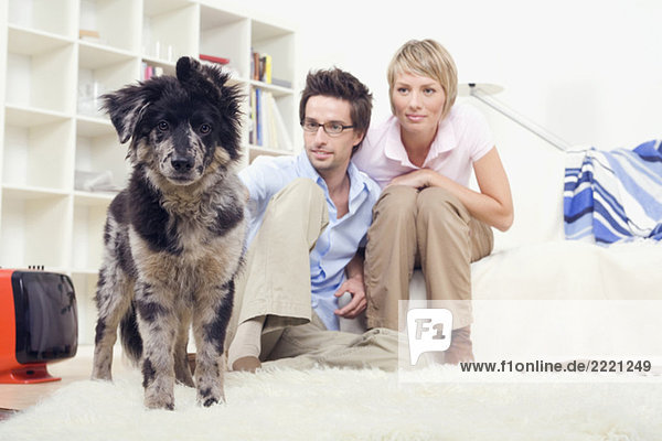 Couple in living room  with dog  portrait