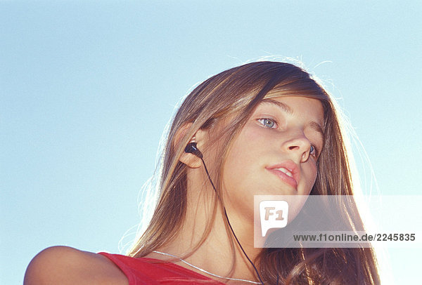 Teenage girl with earpiece