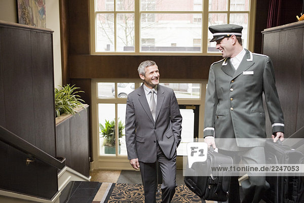Kaufmann und Hotelpage Treppe hinauf zu Fuß