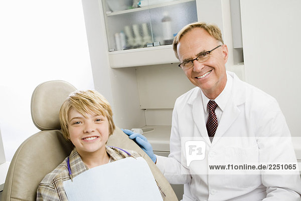 Male dentist and boy in dentist’s office