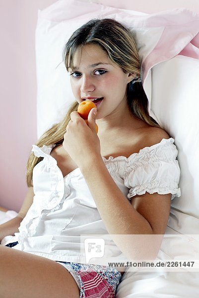 Girl eating apricot