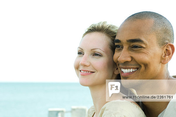 Couple looking away and smiling together  close-up