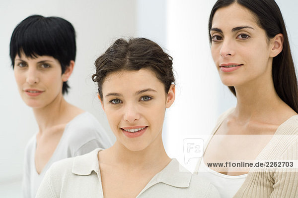 Three businesswomen smiling at camera  portrait