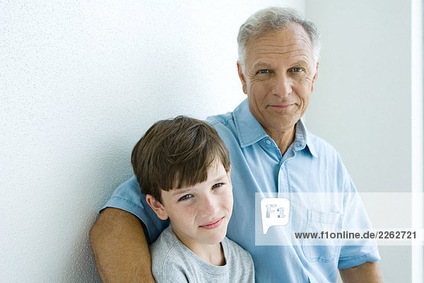 Grandfather and grandson smiling at camera together  portrait