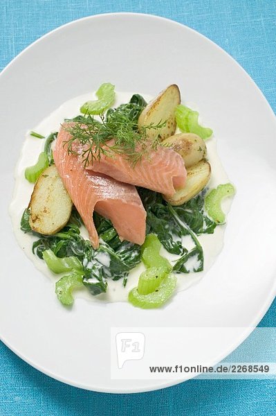 Salmon trout fillet with spinach  celery and potatoes