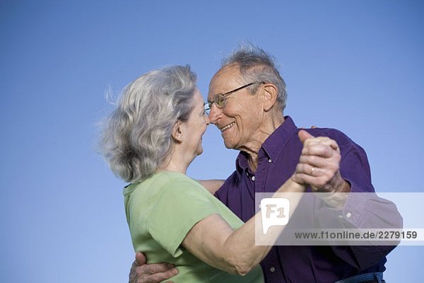 A senior couple dancing
