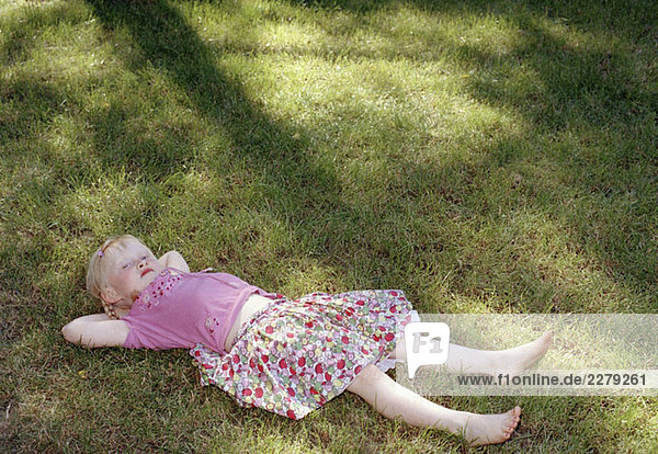 A girl lying on grass