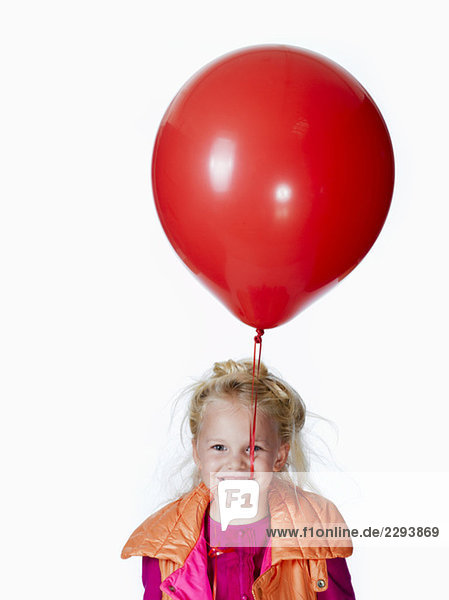 Girl (8-9) holding red balloon  portrait
