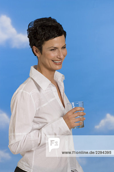 Junge Frau mit Wasserglas  lächelnd  Portrait