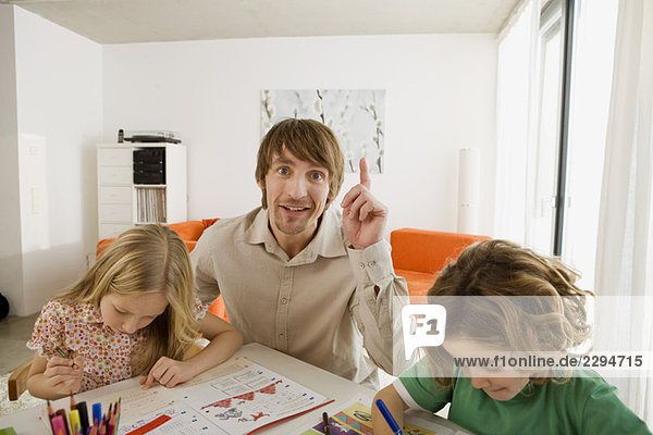 Father and children doing homework