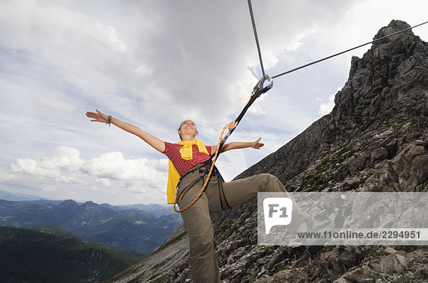 Austria  Salzburger Land  young woman mountain climbing