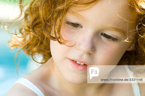 Little girl with red hair looking down  portrait