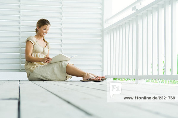 Frau auf der Veranda sitzend Lesebuch  Blickwinkel niedrig