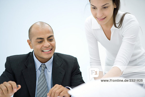 Two business associates working together  smiling