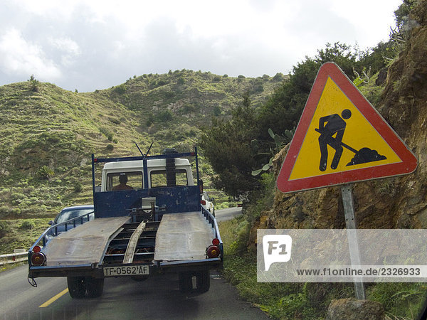 Lastwagen in Bewegung in der Nähe von Bau Straßenschild  La Gomera  Kanaren  Spanien