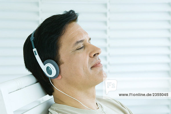 Mann hört Kopfhörer  Augen geschlossen  Profil