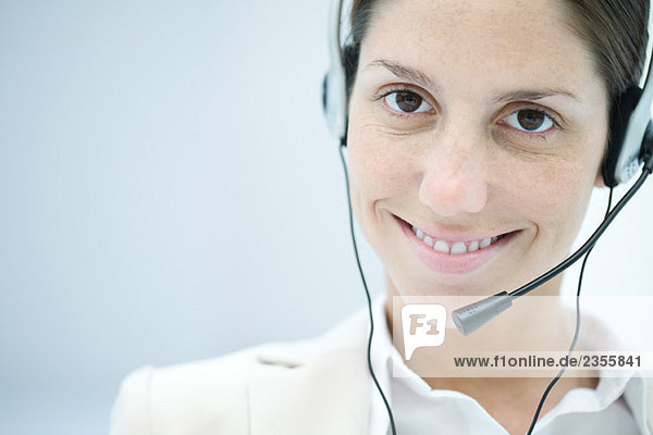 Woman wearing headset  smiling at camera
