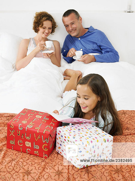 Girl on bed  looking at birthday card