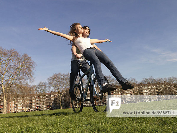 Man and woman riding bicycle