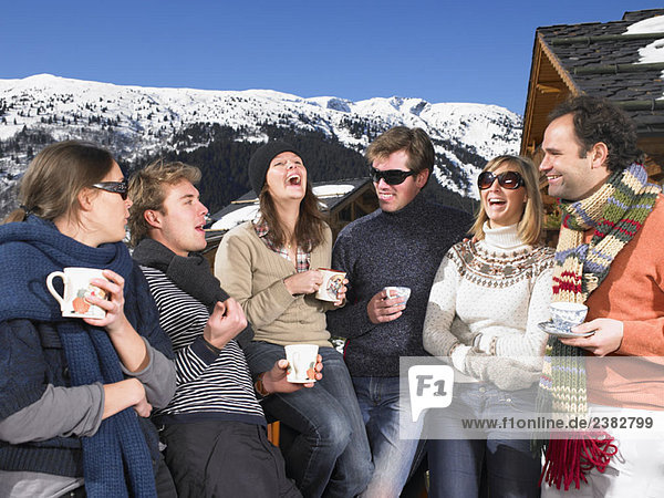 Group of friends on terrace at mountains