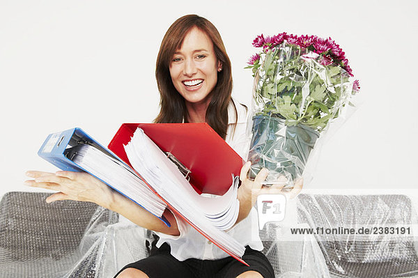 Woman laughing as she drops files