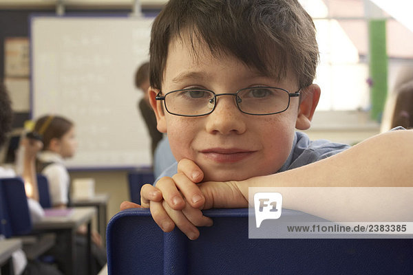 Boy looking at camera  in classroom