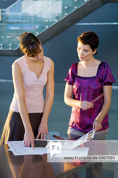 Two interior designers discussing on a color swatch