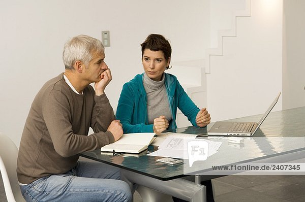 Mature man and a mid adult woman planning their finances