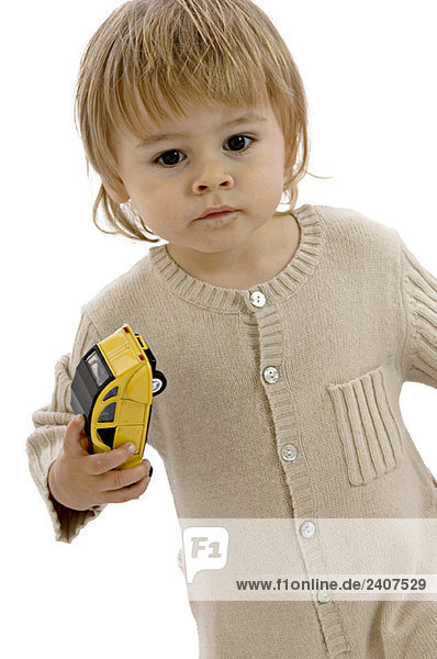 Porträt eines kleinen Jungen mit einem Spielzeugauto