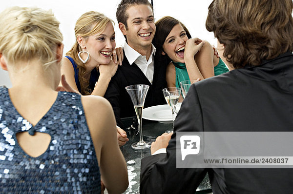 Five people enjoying a dinner party