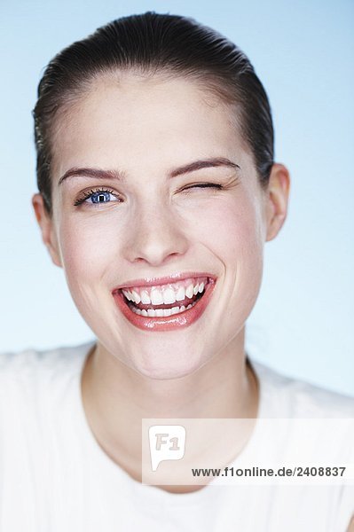 Portrait of young smiling woman winking