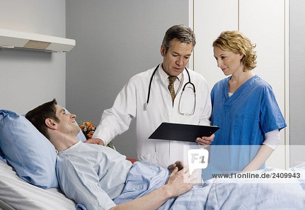 Two healthcare workers speaking to a patient