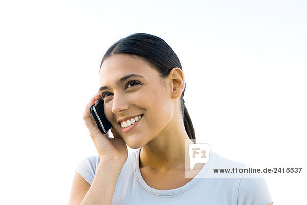 Woman using cell phone  smiling