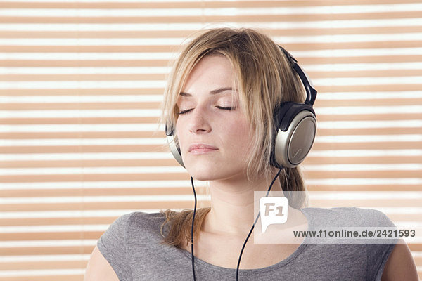 Blonde wearing headphones  eyes closed  portrait