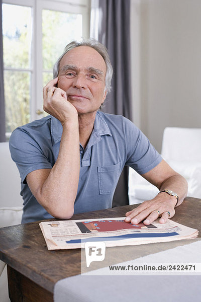 Senior man sitting at table portrait