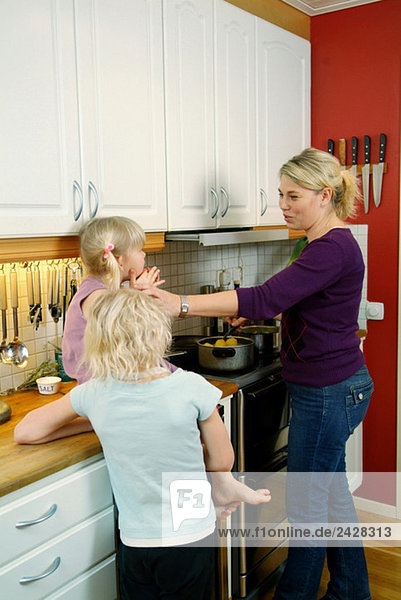 Mother and daughter preparing dinner in kitchen