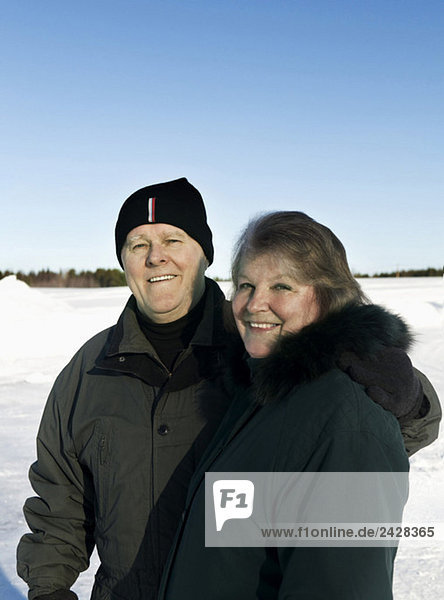 Elderly couple in winter landscape
