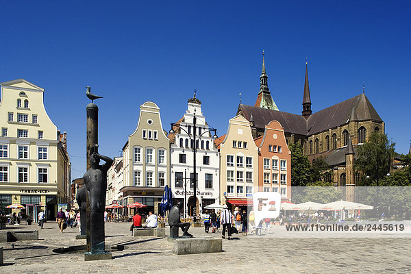 Sculptures at town square with church in background  St MaryÂ´s Church  Rostock  Mecklenburg-West Pomerania  Germany