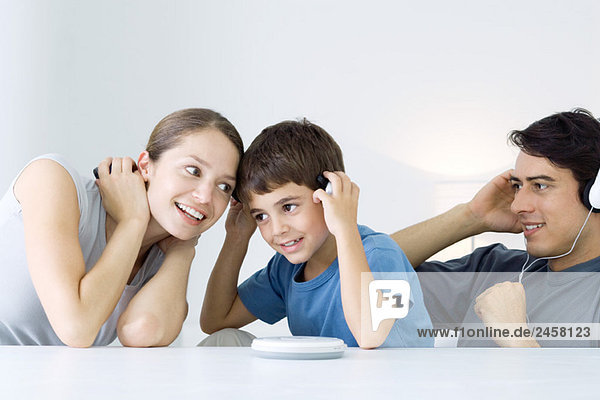 Familie hört gemeinsam CD-Player  Mutter und Sohn teilen sich Kopfhörer