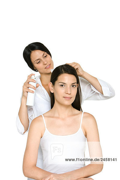 Woman having her hair styled  smiling at camera