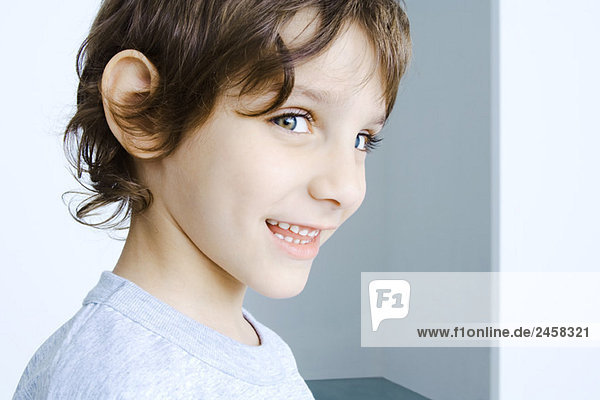 Boy smiling at camera  head and shoulders  portrait