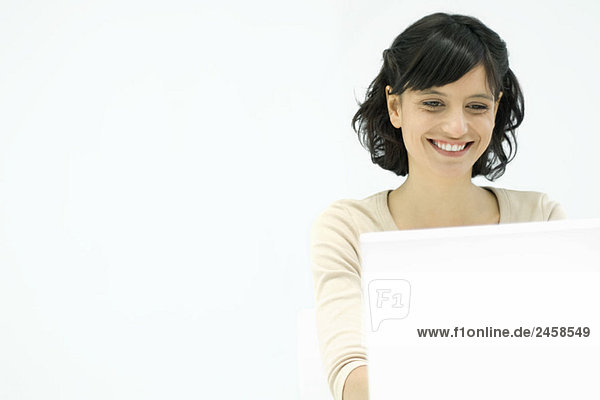 Woman using laptop computer  smiling